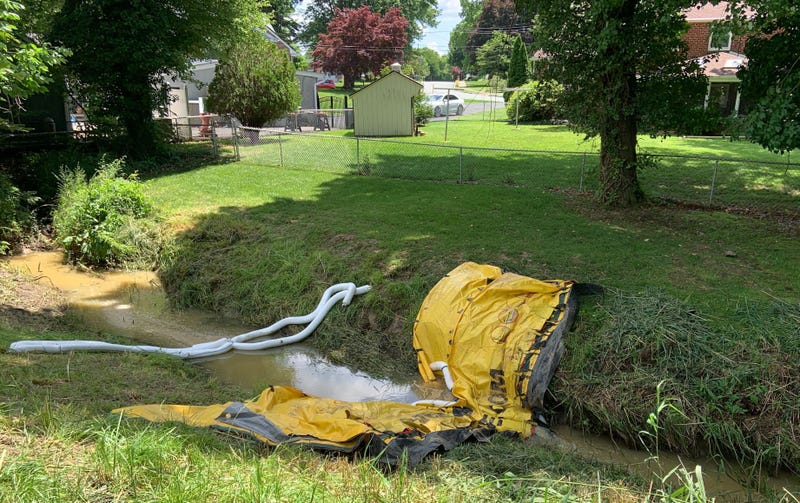 water booms soak up gasoline-contaminated water in Brookhaven