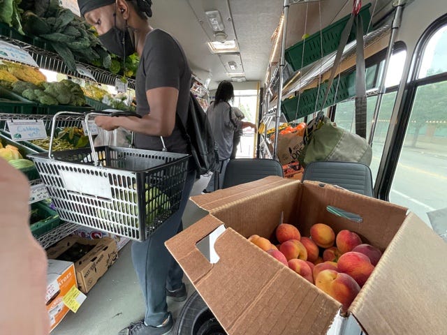 People shopping the Fresh Moves Mobile Market