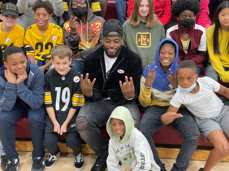 Najee Harris in the stands with students