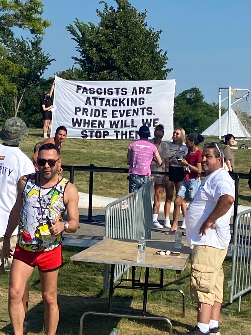 Demonstrators hoist a sign at a Pride event on Governors Island