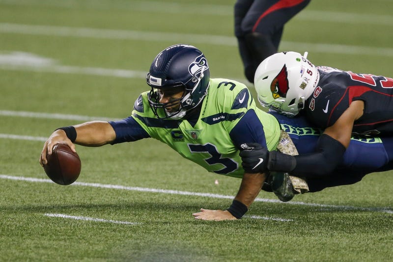 Russell Wilson stretches for extra yards while being tackled