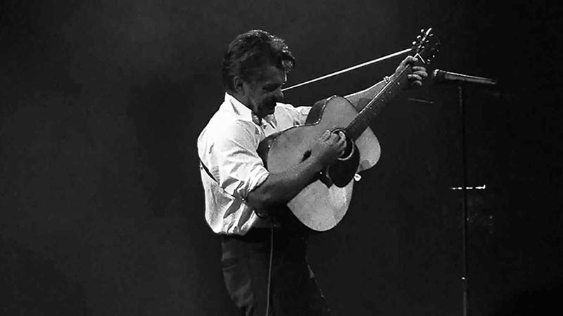 John Mellencamp playing guitar in black and white