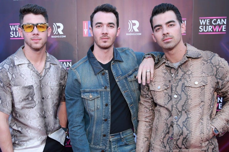 Nick Jonas, Kevin Jonas and Joe Jonas of Jonas Brothers attend the meet and greet during the 7th Annual We Can Survive, presented by AT&T, a RADIO.COM event