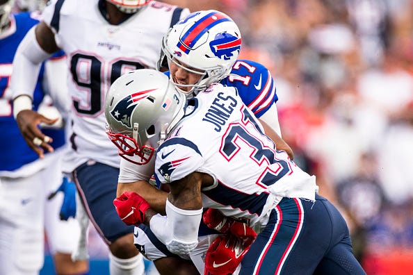 Josh Allen is hit by Patriots cornerback Jonathan Jones.