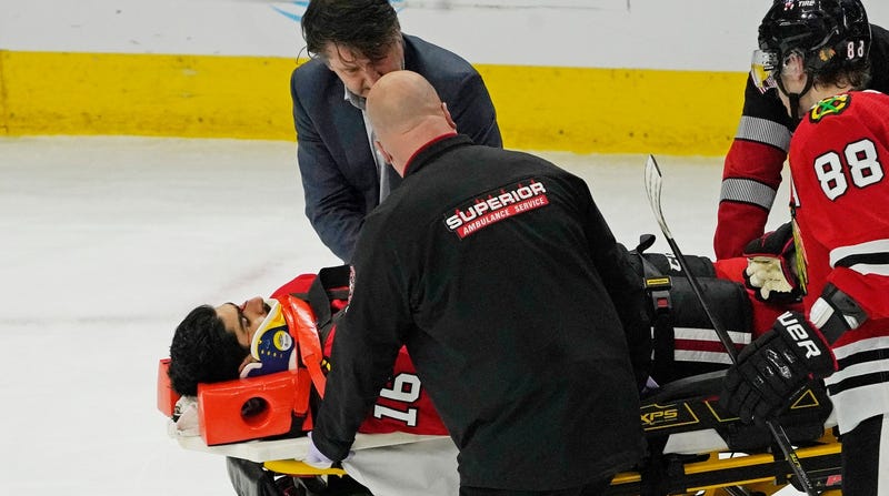 Blackhawks forward Jujhar Khaira is taken off on a stretcher after suffering a serious injury Tuesday.