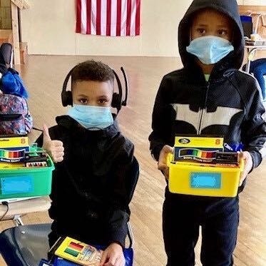 From left: Khamir and Khasim Washington attend virtual school at one of the city's public access centers.