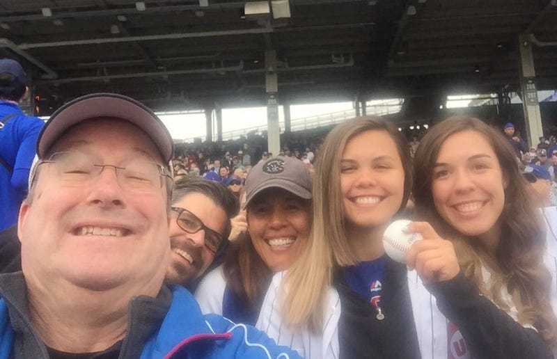Lin Brehmer, left, and the Spiegel family enjoy a Cubs game together.