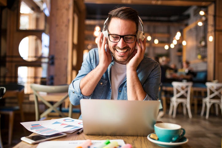 Man laughing, wearing headphones