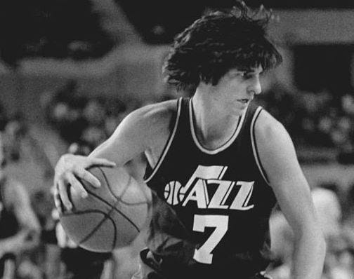 Pete Maravich dribbles the basketball.