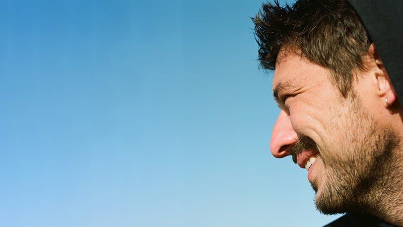 Marcus Mumford profile on blue background