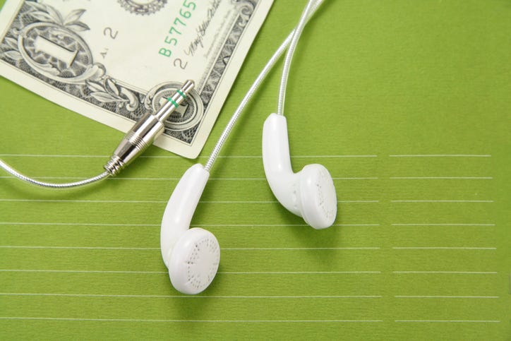 dollar bill with headphones next to it