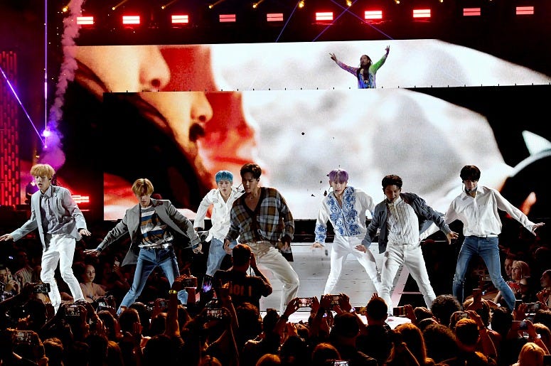 Monsta X perform onstage with Steve Aoki