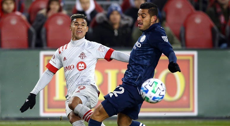 Erickson Gallardo of Toronto FC passes the ball as Ronald Matarrita of New York City FC defends during the second half of an MLS game at BMO Field on March 7, 2020 in Toronto, Canada.