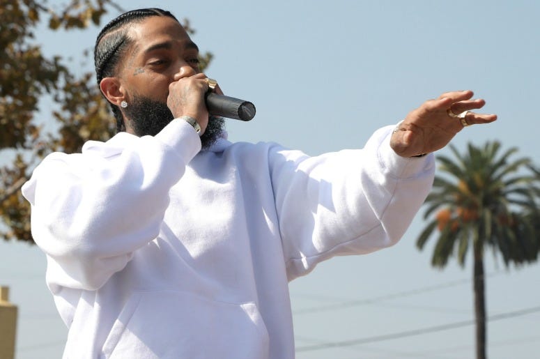 Nipsey Hussle speaks to kids at the Nipsey Hussle x PUMA Hoops Basketball Court Refurbishment Reveal Event on October 22, 2018
