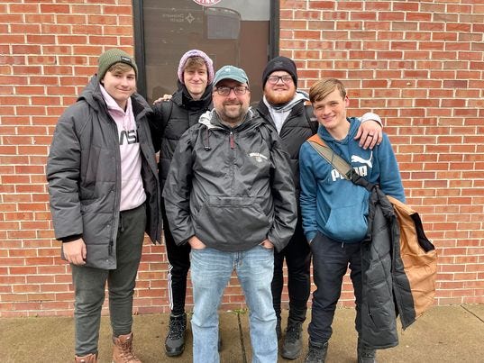 Pastor Eric Johns (center) with his two sons and nephews, embarking on a week with the homeless