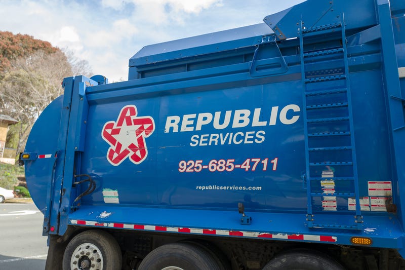 A Republic Services truck arrives at an apartment dumpster