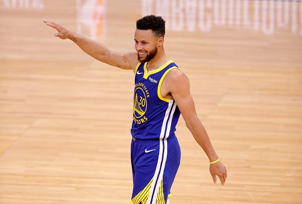 Steph Curry smiles during a Warriors game.