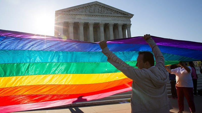 Supporters of same-sex marriage unfurl a large rainbow pride flag near the Supreme Court, April 28, 2015 in Washington, DC.