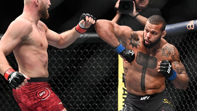 Thiago Santos blocks a punch from Jan Blachowicz in a win at UFC Fight Night 145 in Prague.