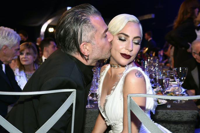Christian Carino kisses Lady Gaga on the cheek.