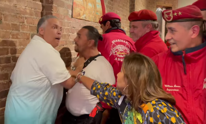 Patrons and members of the Guardian Angels, including Republican mayoral candidate Curtis Sliwa, attempt to break up a fight Friday night at Il Piccolo Buffalo in Little Italy.