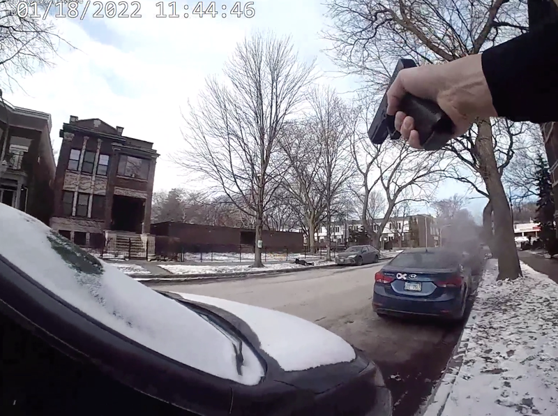 screen grab of officer with drawn weapon