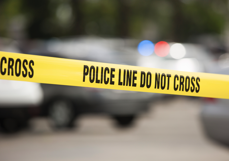 crime scene tape and police lights