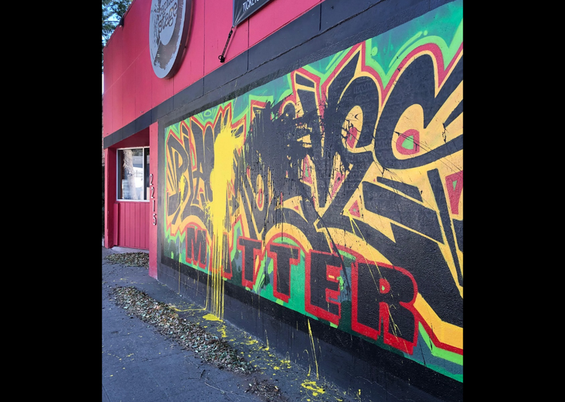 Black and yellow paint splattered on a Black Lives Matter mural in Sacramento.