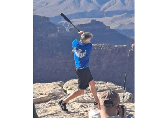 It appeared as if the man was being photographed and was hitting off a tee.