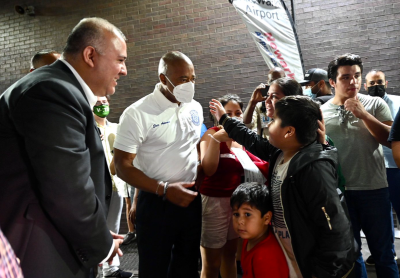 Adams speaks to a group of migrants sent from Texas at Port Authority Bus Terminal.