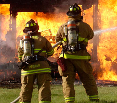 Firefighters battling a blaze. Not the specific fire in which six cats and one dog were killed on Friday.