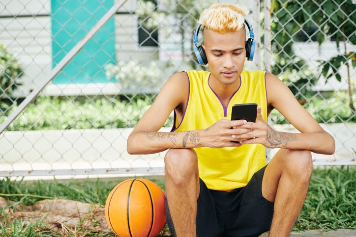 man with basketball and headphones on