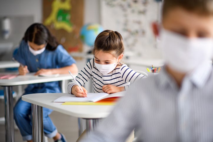 Students wear masks while working on projects