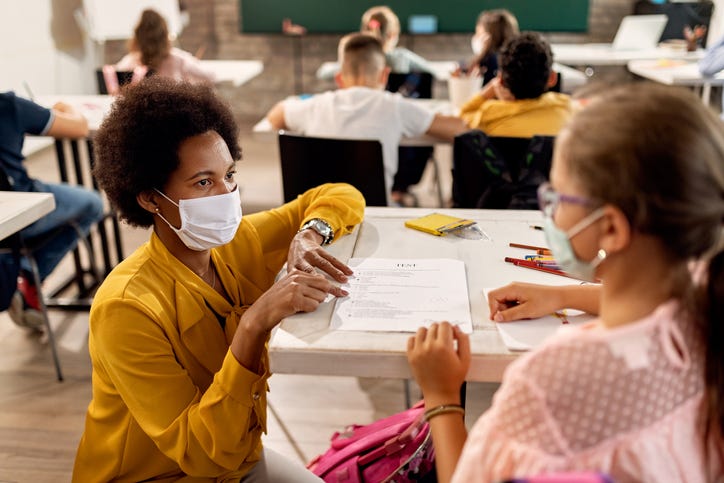 Teacher and student wearing masks