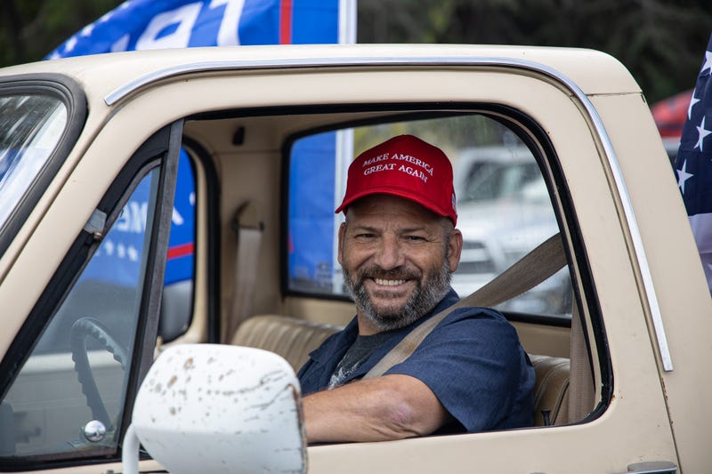 A Trump supporter smiles from his truck.