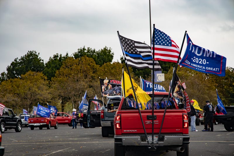 Trucks gather in the parking lot of Stoneridge Mall, decorated with flags showing support for President Trump.