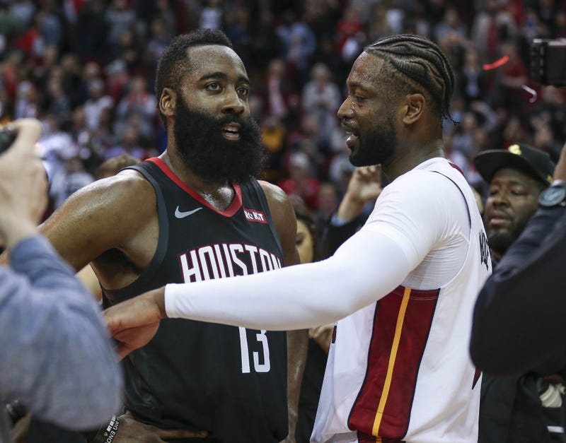 James Harden and Dwyane Wade talk on the court after the game at Toyota Center