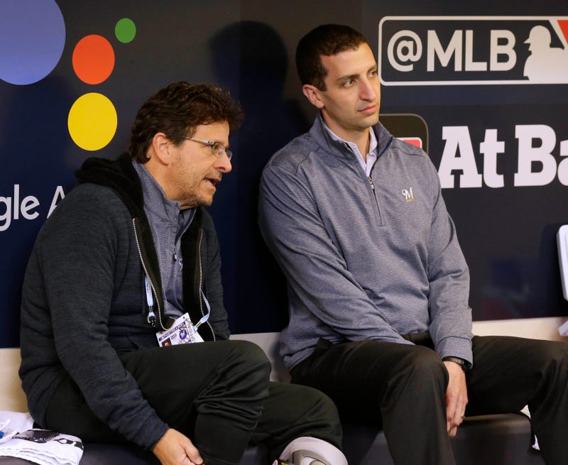 Brewers' GM David Stearns and owner Mark Attanasio chat in the dugout.