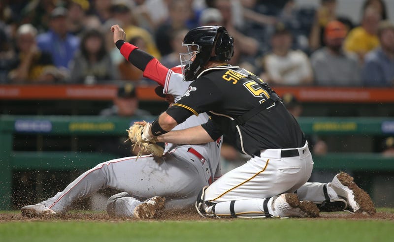 Pittsburgh Pirates catcher Jacob Stallings (58) tags Cincinnati Reds shortstop Jose Iglesias (4) out at home plate