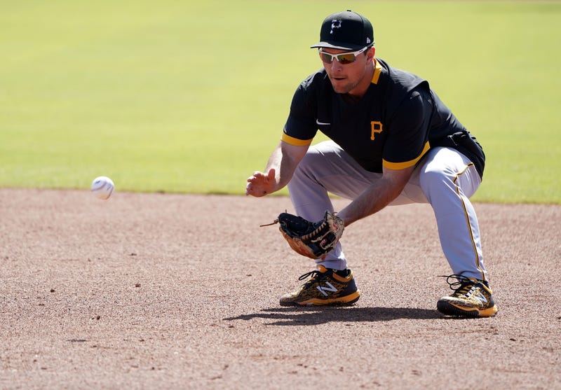 Pirates second baseman fielding a grounder