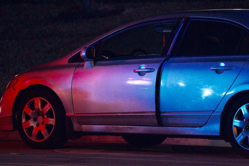 An attempted carjacked Honda Civic is seen along the side on a road