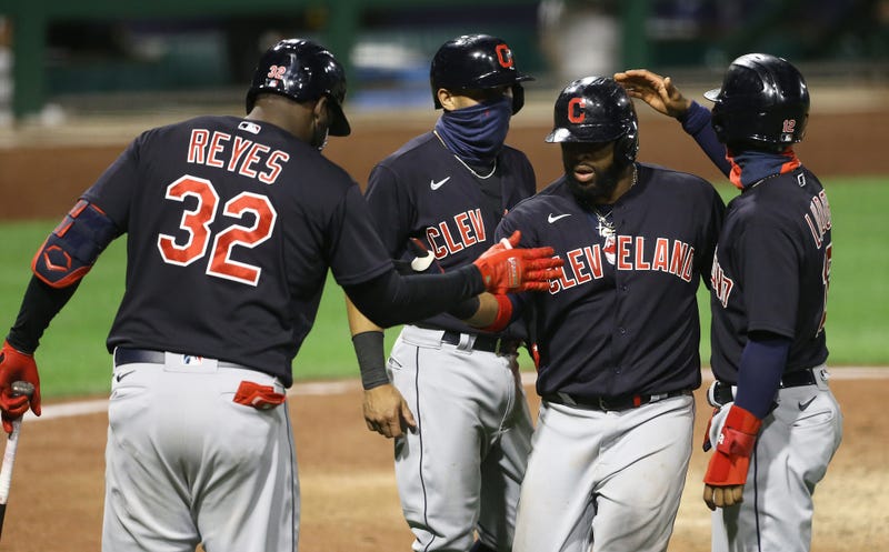 Cleveland Indians designated hitter Franmil Reyes (32) and second baseman Cesar Hernandez (7) and shortstop Francisco Lindor (12) congratulate first baseman Carlos Santana (middle right) on his three run home run against the Pittsburgh Pirates during the tenth inning at PNC Park.