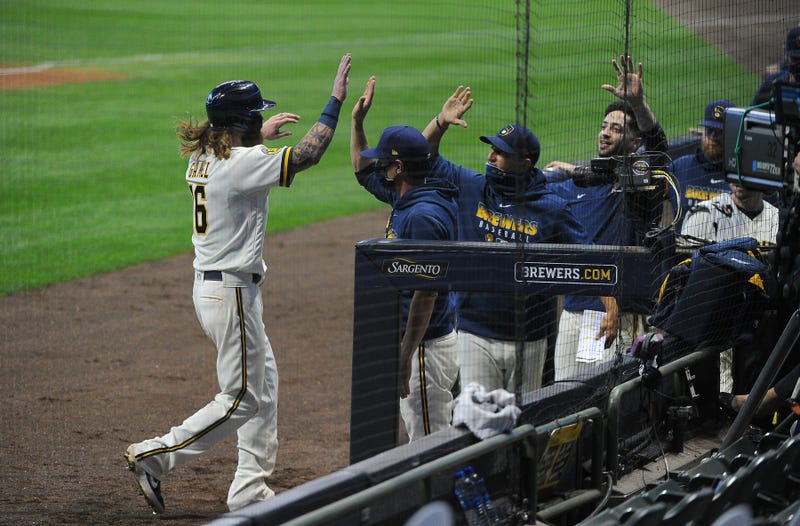 Brewers right fielder Ben Gamel (16) is greeted with high-fives in the Milwaukee Brewers dug out as he scores a run against the Pittsburgh Pirates