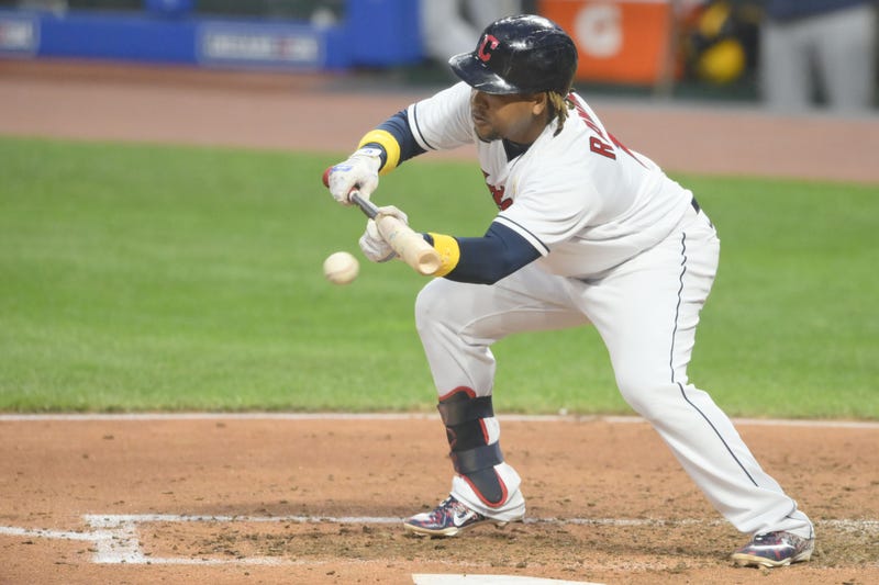 Cleveland Indians third baseman Jose Ramirez (11) bunts for a base hit in the third inning against the Milwaukee Brewers at Progressive Field.