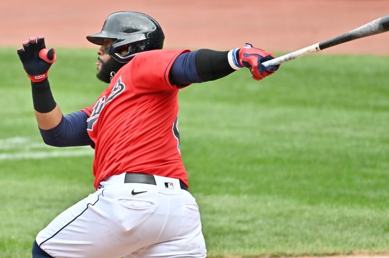 Sep 6, 2020; Cleveland, Ohio, USA; Cleveland Indians first baseman Carlos Santana (41) hits an RBI single during the sixth inning against the Milwaukee Brewers at Progressive Field. Mandatory Credit: Ken Blaze-USA TODAY Sports