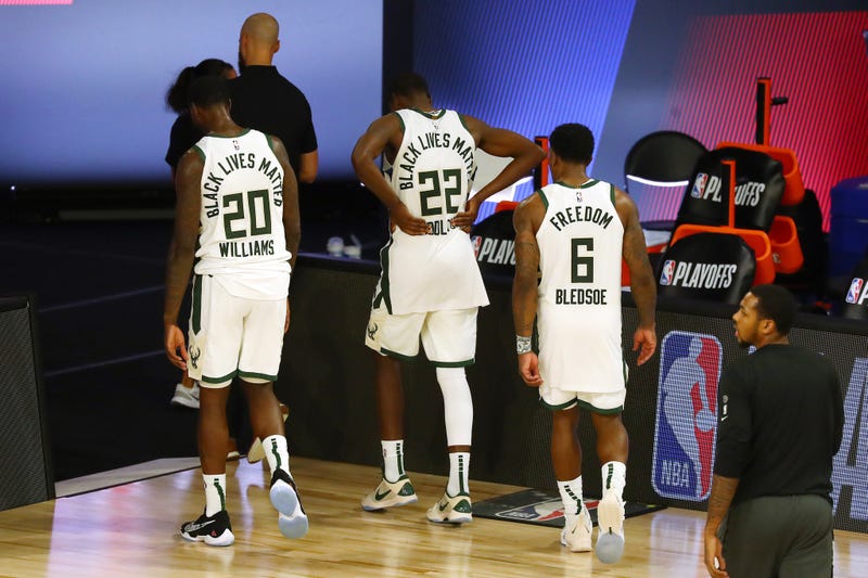 Members of the Bucks walk off the floor for the final time in 2020