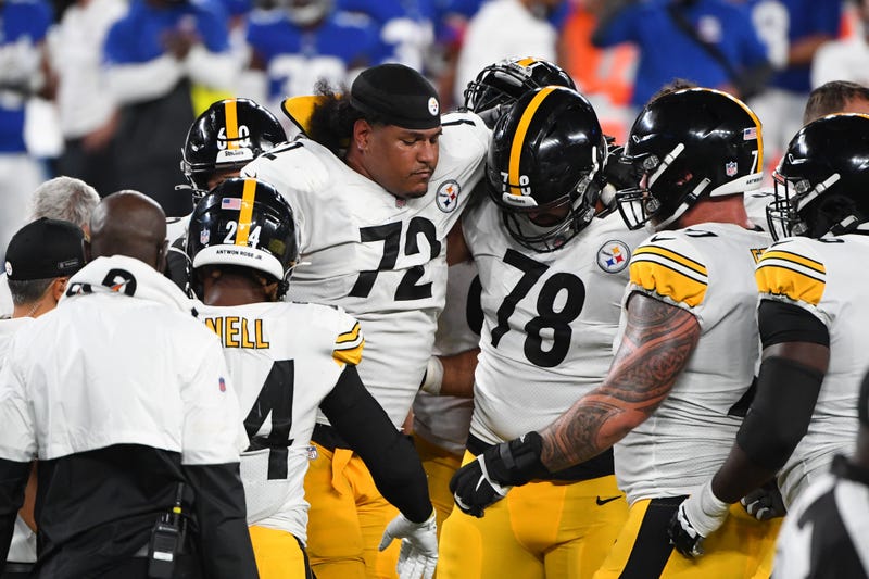Zach Banner being carried off the field after an apparent ACL injury