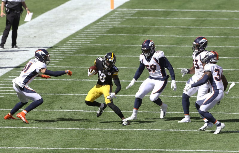 Steelers wide receiver Diontae Johnson (18) runs after a catch as the Denver Broncos defense defends during the second quarter at Heinz Field.