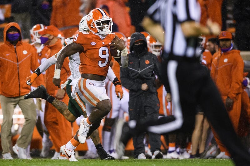 Clemson Tigers running back Travis Etienne (9) runs for a 72-yard touchdown against the Miami Hurricanes during the third quarter at Memorial Stadium.