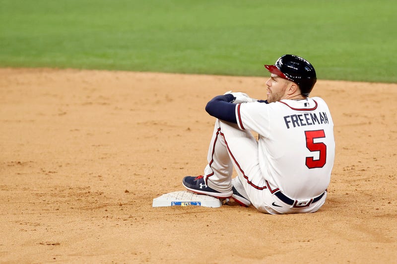 Atlanta Braves first baseman Freddie Freeman (5) rests on first base after sliding in safely for a double during the eighth inning against the Los Angeles Dodgers in game five of the 2020 NLCS